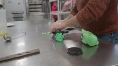 baker filling professional moulds with coloured dough preparing heart and star shaped bread cookies for event holidays valentine finger food 4k footage