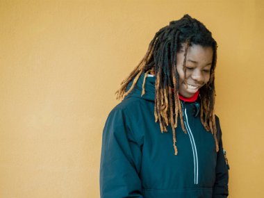 Cheerful young teengaer africna american woman dressed in sportswear smiling pleasant having fun enjoying relaxing