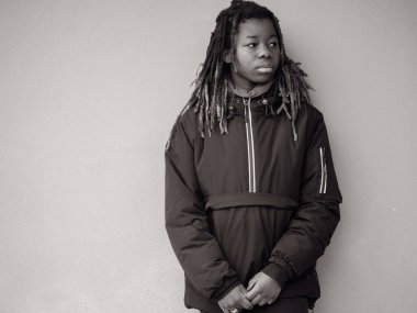 Cheerful young teengaer africna american woman dressed in sportswear relaxed with serious expression on face