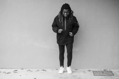 Cheerful young teengaer africna american woman dressed in sportswear expressing