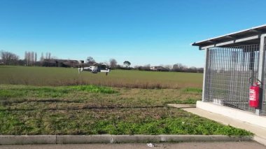 Piacenza, Italy - January 2023 a Dji uav drone quadcopter hovering a high wind sunny day video footage hd