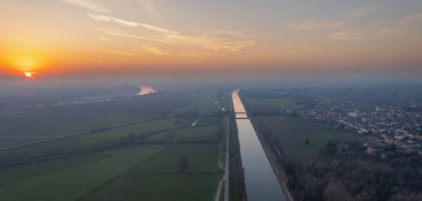Cremona, Italy - January 2023 drone view at sunset in Spinadesco canal and river po scenic pano