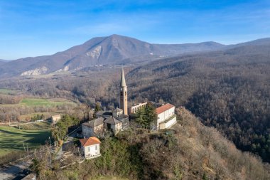 Morfasso, Piacenza, Emilia Romagna, Italy Drone view of Our Lady of Lourdes Grotto - Sperongia Parish and hills a sunny day