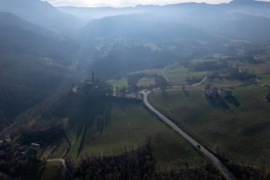Morfasso, Piacenza, Emilia Romagna, Italy Drone view of Our Lady of Lourdes Grotto - Sperongia Parish and hills a sunny day