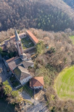 Morfasso, Piacenza, Emilia Romagna, Italy Drone view of Our Lady of Lourdes Grotto - Sperongia Parish and hills a sunny day