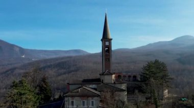 Morfasso, Piacenza, Emilia Romagna, Italy Drone view of Our Lady of Lourdes Grotto - Sperongia Parish and hills a sunny day aerial footage