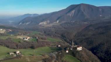 Morfasso, Piacenza, Emilia Romagna, Italy Drone view of Our Lady of Lourdes Grotto - Sperongia Parish and hills a sunny day aerial footage