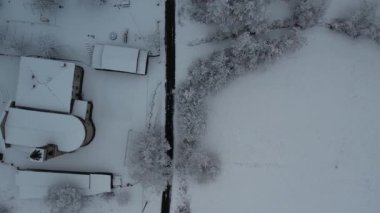 Aerial shot of winter landscape near italian apennines woods and hills covered in snow near Vezzolacca Italy drone video