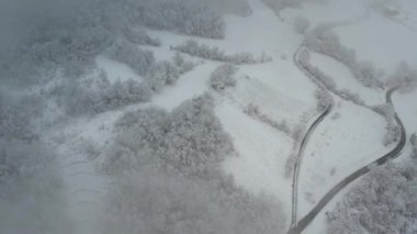 Aerial shot of winter landscape near italian apennines woods and hills covered in snow near Vezzolacca Italy drone video