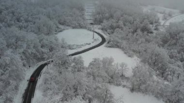 Aerial shot of winter landscape near italian apennines woods and hills covered in snow near Vezzolacca Italy drone video