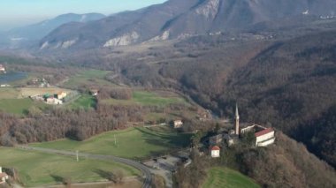 Morfasso, Piacenza, Emilia Romagna, Italy Drone view of Our Lady of Lourdes Grotto - Sperongia Parish and hills a sunny day aerial footage