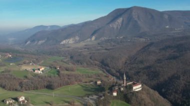 Morfasso, Piacenza, Emilia Romagna, Italy Drone view of Our Lady of Lourdes Grotto - Sperongia Parish and hills a sunny day aerial footage