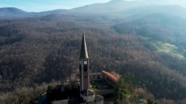 Morfasso, Piacenza, Emilia Romagna, Italy Drone view of Our Lady of Lourdes Grotto - Sperongia Parish and hills a sunny day aerial footage