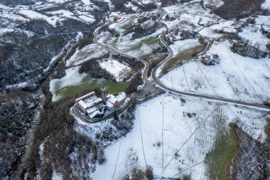 Morfasso, Piacenza, Emilia Romagna, Italy Drone view panorama of Our Lady of Lourdes Grotto - Sperongia Parish and hills a sunny day