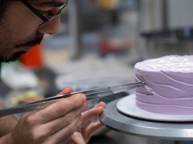 20 years old frosted cake decorated with a cream handmade phrase, pearls , sprinkles by baker designer