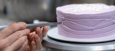 20 years old frosted cake decorated with a cream handmade phrase, pearls , sprinkles by baker designer