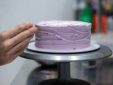 20 years old frosted cake decorated with a cream handmade phrase, pearls , sprinkles by baker designer