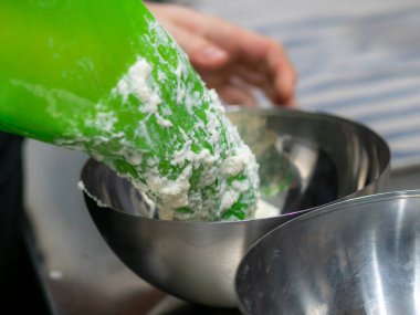 pink icing piping filling for frosted cake decoration in kitchen lab