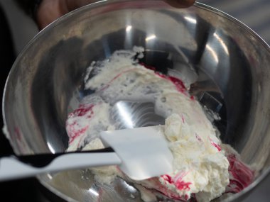 pink icing piping filling for frosted cake decoration in kitchen lab