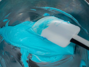 turquoise icing piping filling for frosted cake decoration in kitchen lab