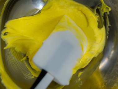 yellow icing piping filling for frosted cake decoration in kitchen lab