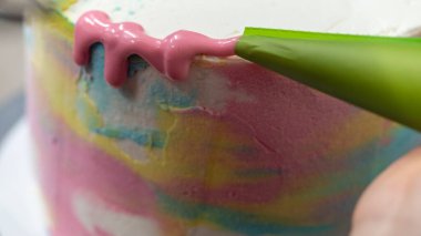pastry chef designer making a football soccer ball as a frosted cake topper photo