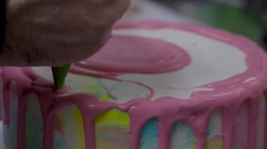 Pasta tasarımcısı Pinl sarı mercan rengi boru tipi 4K görüntülerle süslenmiş kişniş katmanlı pasta hazırlıyor.