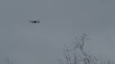 Lombardy, Italy - Jan 2002 Flying 4k gimbal camera drone hovering over blurred landscape background