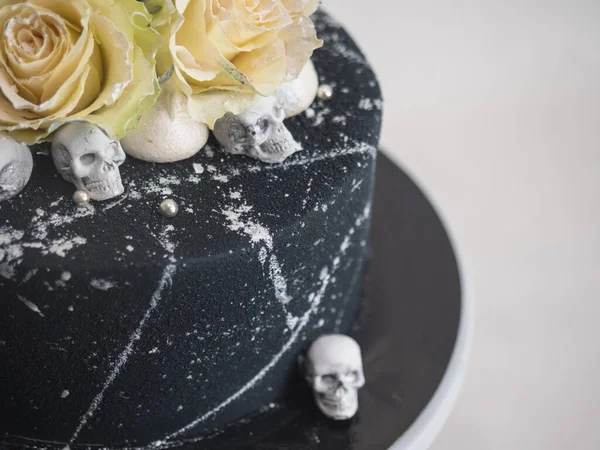 birthday black airbrush painted frosted icing cake, two real roses silver sprayed and edible chocolate skull toppers and silver brush strokes