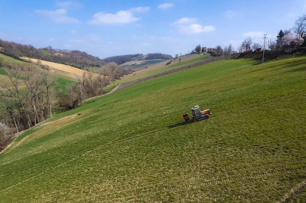 farmer driving uphill crawled tractor in the farm during spring season
