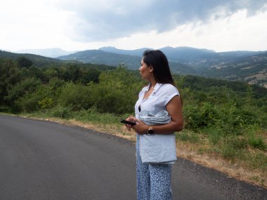 Asyalı Hintli kadın bulutlu bir günde nehri seyrediyor.