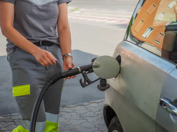 stock image Cremona, Italy - July 3 2023 caucasian service woman at Eni Agip city fuel station pumping petrol to a customer car