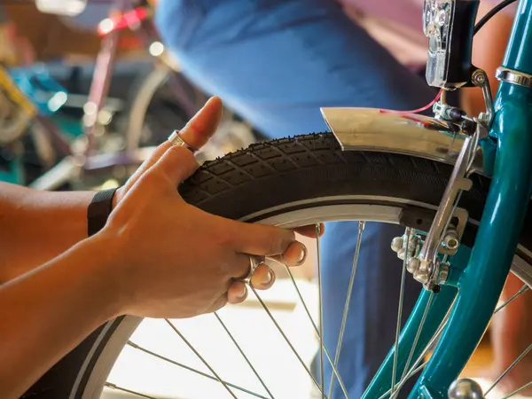 at the bike shop store and repair , artisan expert mechanic expert repairs restore bicycle tires