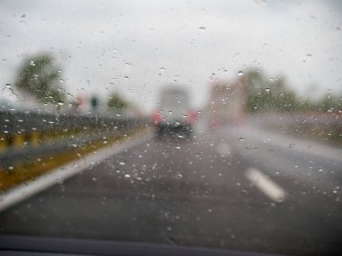 Piacenza, Italy -April 22nd 2024 A highway scene under an overcast sky featuring cars and trucks with road signs and an overpass, rainy day on Motorway A1