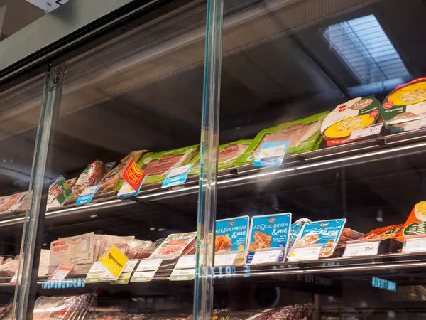 Stock image Cremona, Italy July 19th 2024 Refrigerated display case showing a variety of packaged meat products in a supermarket