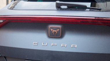 Cremona, Italy September 26th 2024 Close up of the cupra logo on the back of a gray car showing the modern branding of the spanish automobile manufacturer clipart