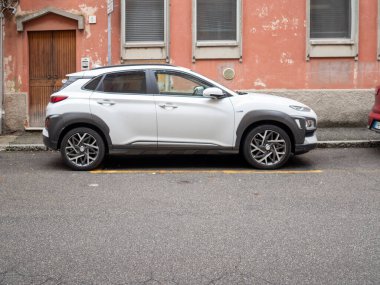 Cremona, Lombardy, Italy October 15th 2024 Modern electric suv parked on a city street, showcasing sustainable urban transportation and eco friendly driving clipart