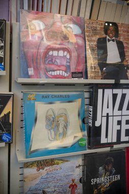 Cremona, İtalya - 27 Kasım 2024 Pembe Floyd plakları. Michael jackson. Ray charles. Yaradılış. Bruce Springsteen hakkında bir kitap bir plak dükkanında raflarda sergileniyor.