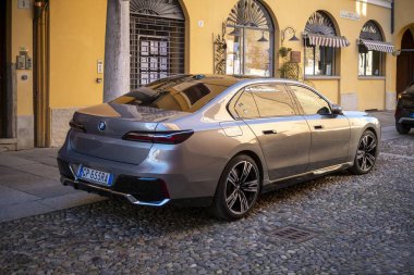 Cremona, Lombardy, İtalya - 27 Ekim 2024 Geleneksel bir Avrupa binasının yakınına park edilmiş lüks gri bmw i7 elektrikli sedan manzarası