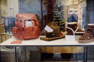 Cremona, Italy - December 24th 2024 Fashion retail store window display showcasing winter accessories and apparel during the Christmas season clipart