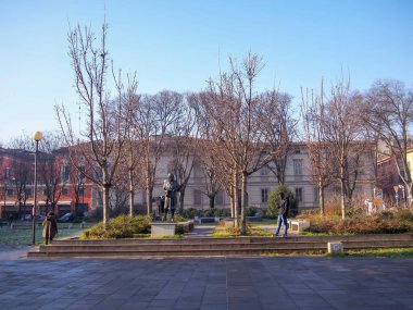 Cremona, Italy November 15th 2021 Bronze statue of Antonio Stradivari, the famous violin maker, located in Piazza Roma, Cremona, Italy, surrounded by bare trees in winter clipart