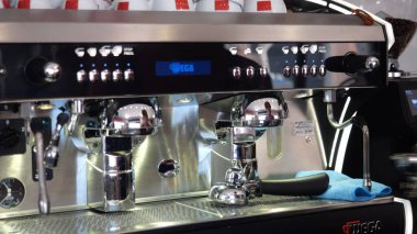 Cremona, İtalya 19 Temmuz 2025 Parlak ve temiz, profesyonel bir Wega espresso makinesi bir Lombardiya barında oturur, krom ve mükemmel İtalyan kahvesi için dijital bir ekran sunar.
