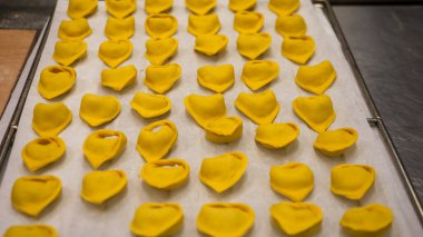 Passionately crafted autumn pumpkin stuffed tortellini fresh pasta preparation in a small business professional kitchen detailed close up shots