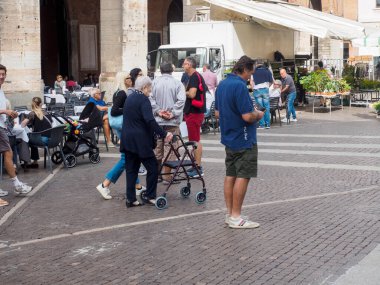 Cremona, Italy - September 18th 2025 Bustling Town Square Market Scene in Historic Lombardy Italy Featuring Locals and Tourists Interacting Among Stalls and Architectural Charm Under Bright Sunny Skies Lively Atmosphere