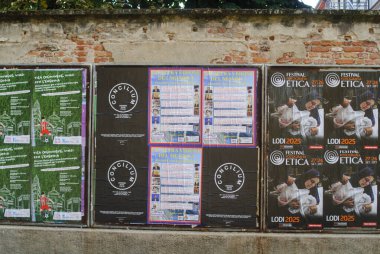 Cremona, Italy September 30th 2025 Multiple identical festival posters pasted on weathered brick and concrete wall in Lodi, Italy urban cultural event announcements