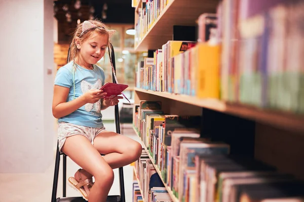 Schoolgirl Looking Book School Library Student Choosing Book Reading Books — Stock Photo, Image