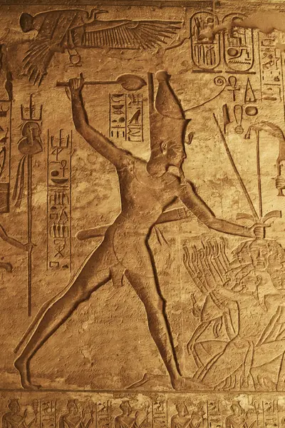 Image and hieroglyphs from The Great Temple of Ramesses II in Abu Simbel. Relief of Egyptian Pharaoh. Popular Egyptian landmarks. Ancient Egypt. Vacation destination. Historic site. Tours and sightseeing