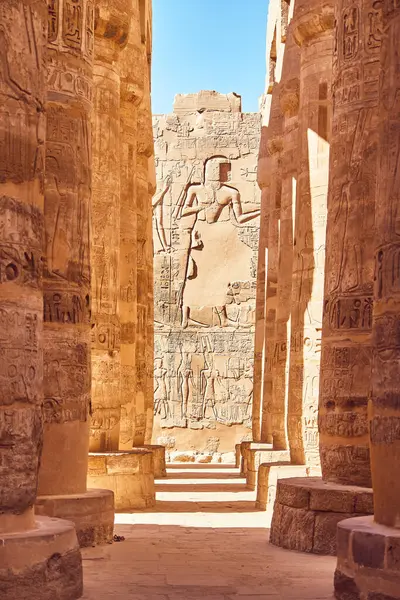 Karnak Temple Great Hypostyle Hall Pillars in Luxor - ancient Thebes. Pillars with Egyptian hieroglyphs. Popular Egyptian landmark. Ancient Egypt. Vacation destination. Historic site. Travel attractions and heritage in Egypt