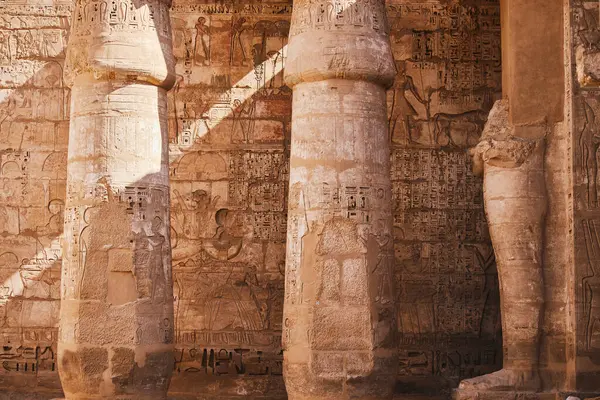 Columns with Egyptian hieroglyphs and ancient symbols. Famous Egyptian landmark. Visiting ancient Egypt. Vacation destination. Historic site. Travel attractions and heritage in Egypt