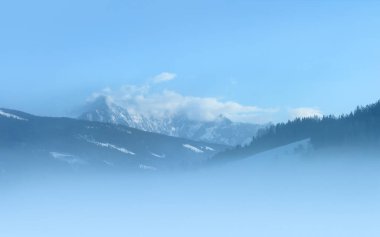 Sisli bir sabahta karlı zirveler. Buzul 'Dachstein' Avusturya 'nın kuzey Alplerinde yer almaktadır. Fotoğraf 'Radstadt' tan..